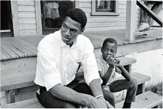 Howard Fuller on the porch of a Durham home. Photograph by Billy E. Barnes, courtesy of the North Carolina Collection, Wilson Library, University of North Carolina at Chapel Hill, Billy Ebert Barnes Collection.